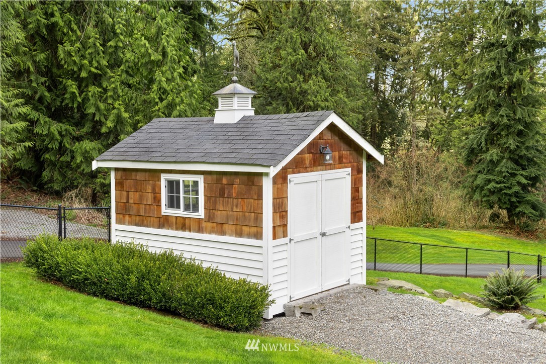 8707 West Snoqualmie Valley Road Northeast Carnation, WA 98014 - Photo 36 of 39 a front view of a house with a yard and trees
