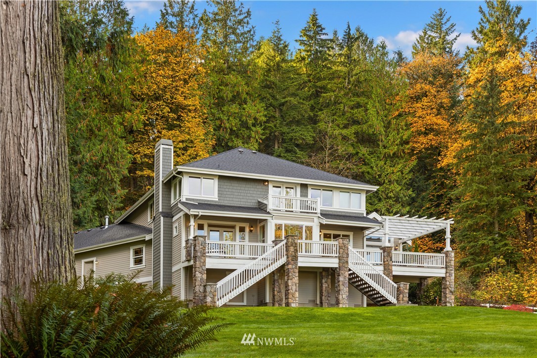 8707 West Snoqualmie Valley Road Northeast Carnation, WA 98014 - Photo 38 of 39 a front view of a house with a garden
