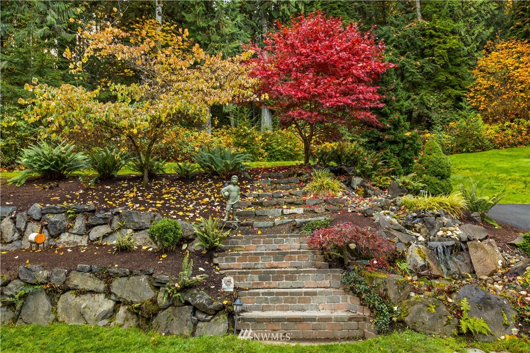 8707 West Snoqualmie Valley Road Northeast Carnation, WA 98014 - Photo 9 of 39 a view of a yard with plants and large trees