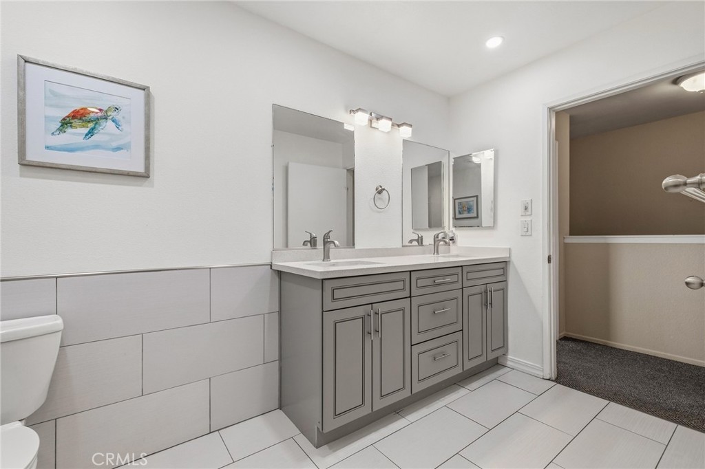 14429 Chardon Avenue, Unit 41 Hawthorne, CA 90250 - Photo 16 of 27 a bathroom with a double vanity sink and a mirror