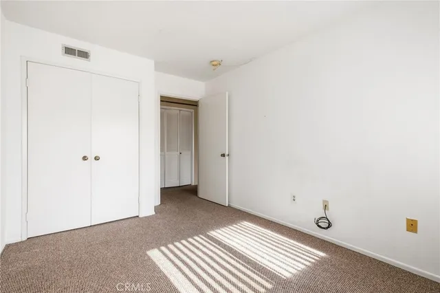 a view of a closet area with ceiling fan