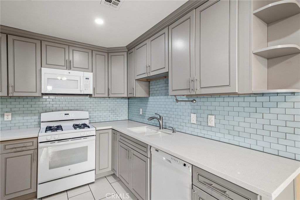 14429 Chardon Avenue, Unit 41 Hawthorne, CA 90250 - Photo 6 of 27 a kitchen with white cabinets stainless steel appliances and sink