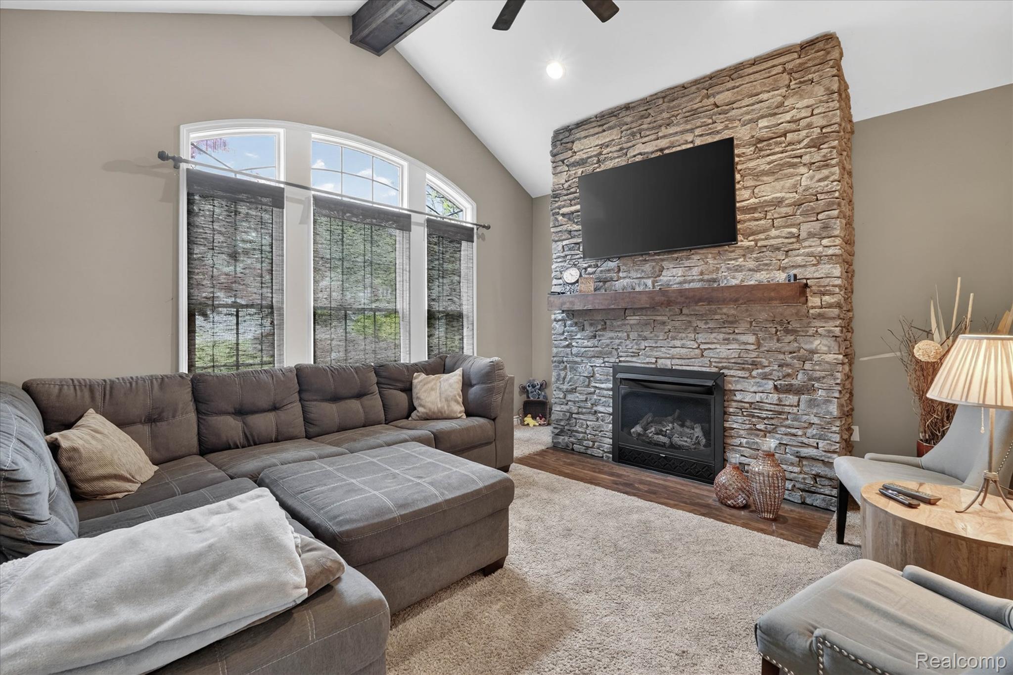 9074 Ridgefield Drive Brighton, MI 48114 - Photo 16 of 75 Living room featuring ceiling fan, a fireplace, and carpet floors