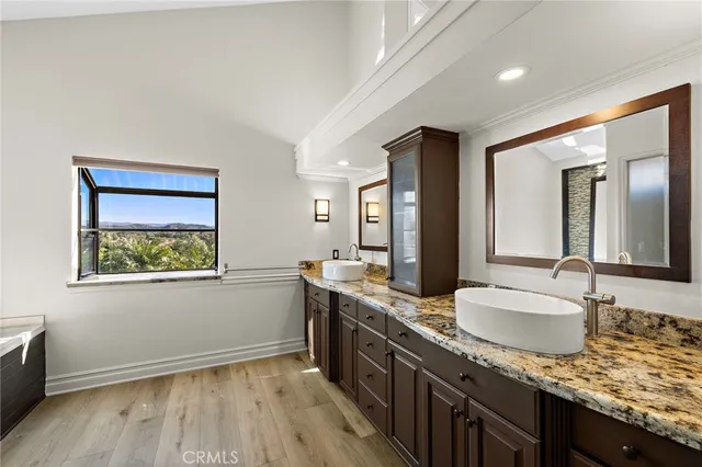a bathroom with a granite countertop sink mirror and vanity