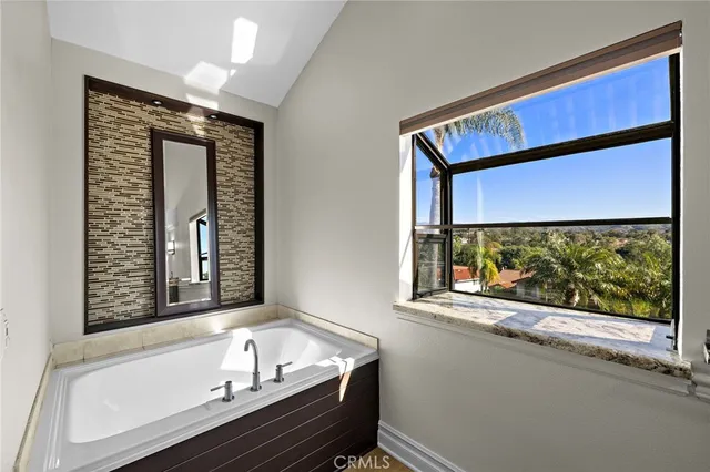 a bathroom with a bathtub and a window