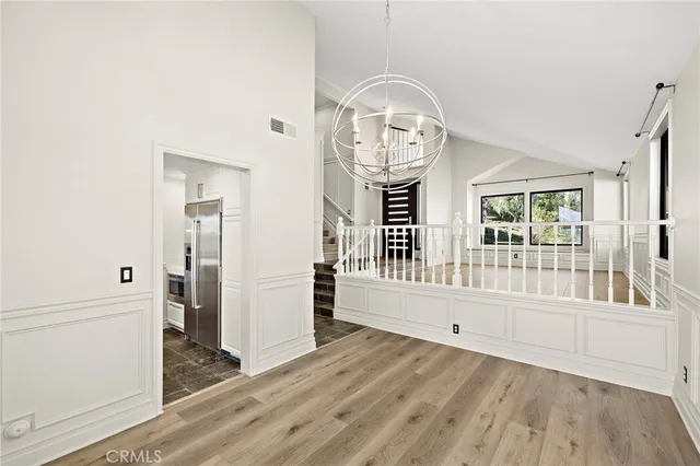 a view of an entryway with wooden floor