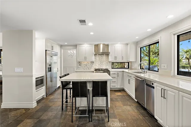 a large kitchen with a table and chairs in it