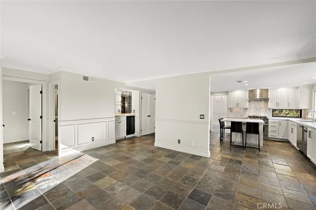 a view of kitchen with furniture and refrigerator