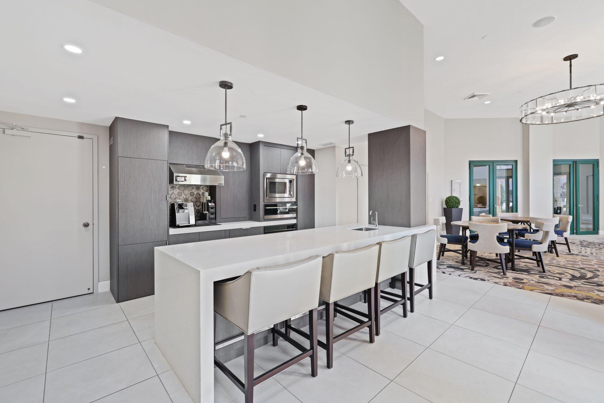 100 Southeast 5th Avenue, Unit 106 Boca Raton, FL 33432 - Photo 67 of 81 a large kitchen with a table and chairs