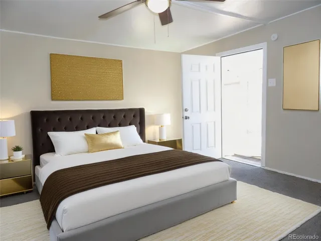 a bedroom with a bed and painting on the wall