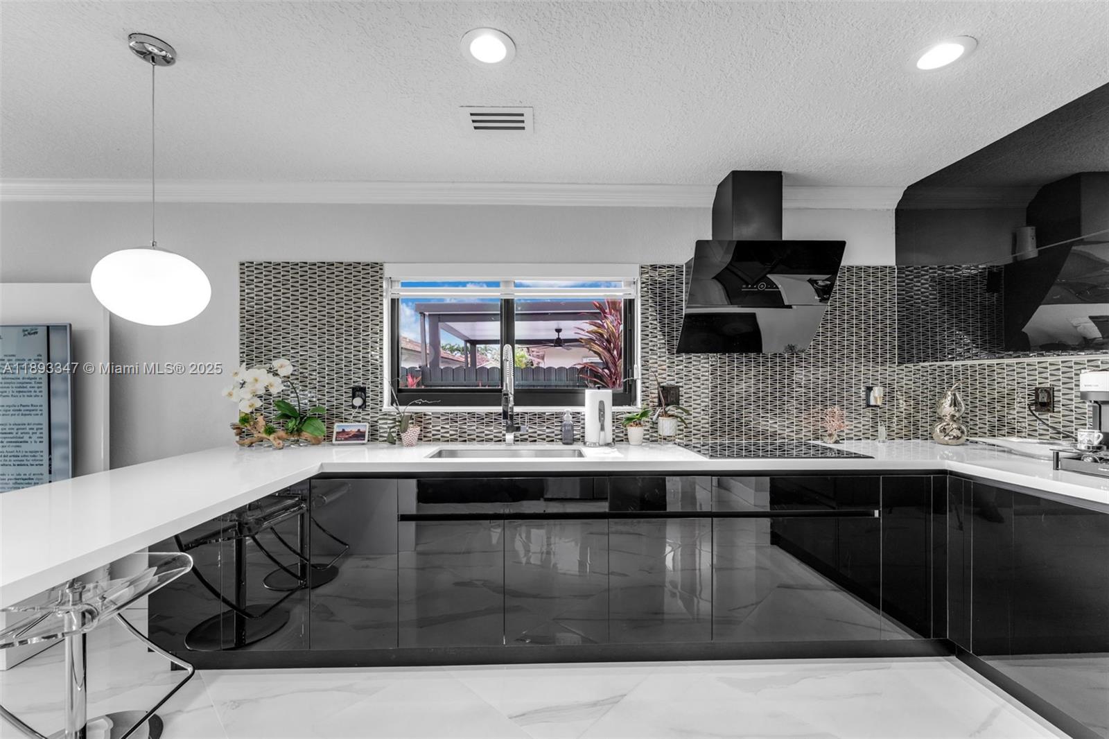 3121 Southwest 151st Court Miami, FL 33185 - Photo 11 of 37 a kitchen with kitchen island granite countertop a sink a stove and cabinets