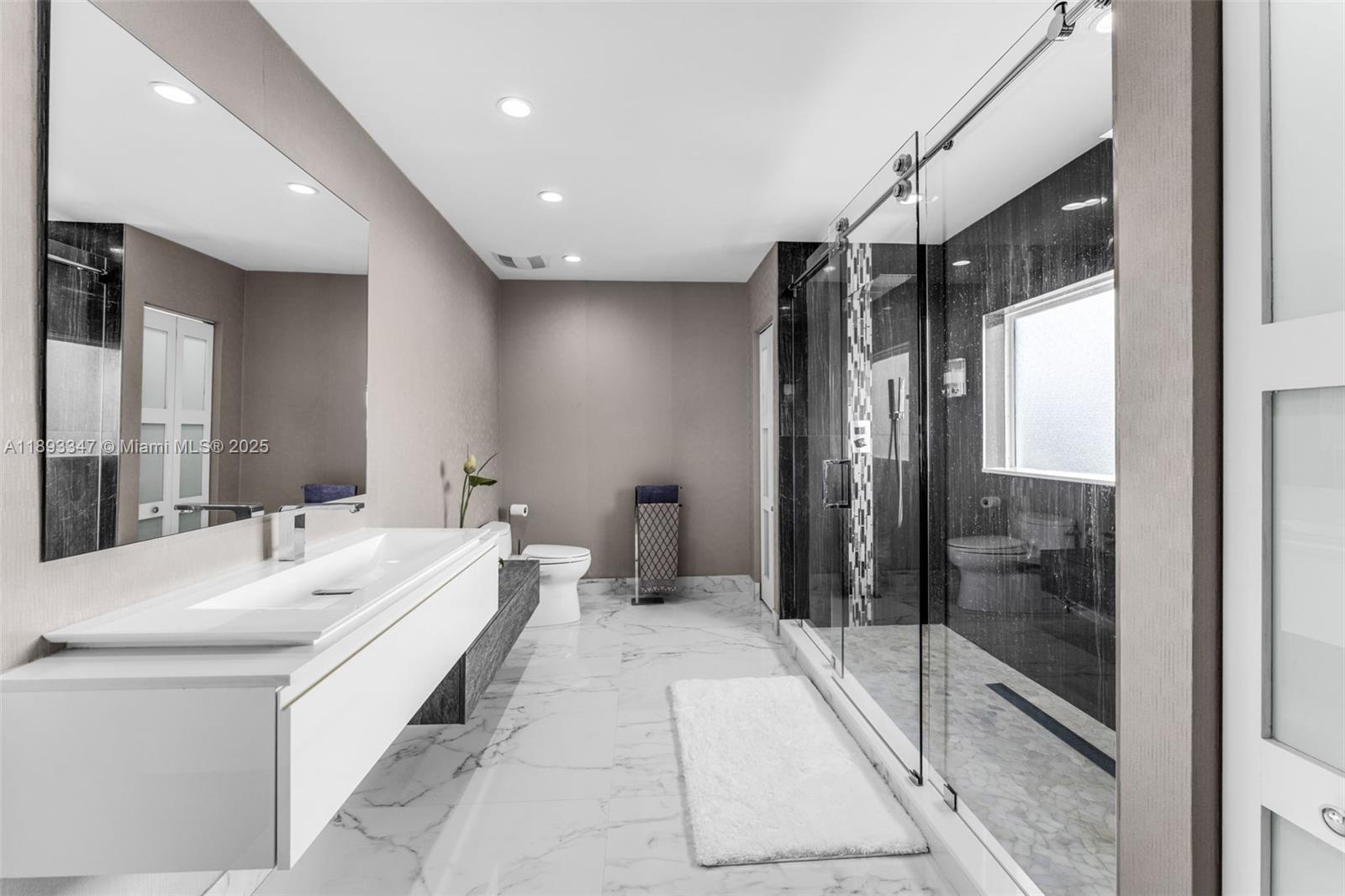 3121 Southwest 151st Court Miami, FL 33185 - Photo 17 of 37 a bathroom with a double vanity sink mirror and shower