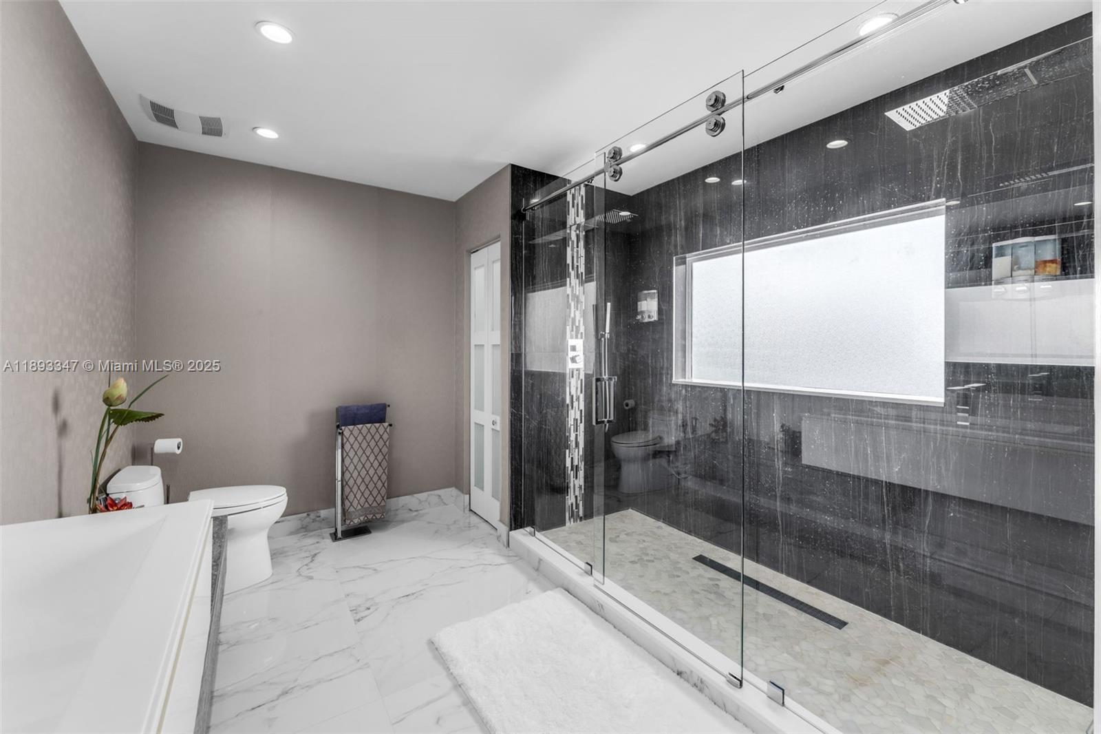 3121 Southwest 151st Court Miami, FL 33185 - Photo 18 of 37 a bathroom with a bathtub and a shower