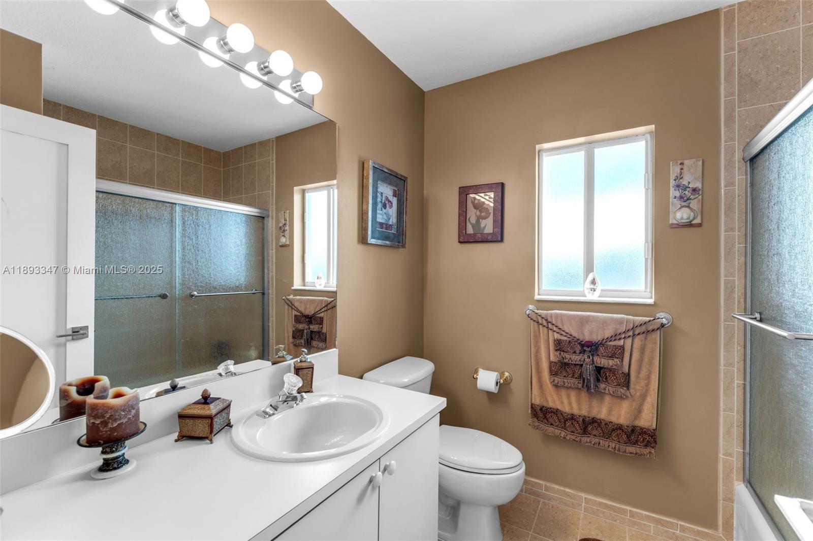 3121 Southwest 151st Court Miami, FL 33185 - Photo 21 of 37 a bathroom with a sink vanity mirror and toilet