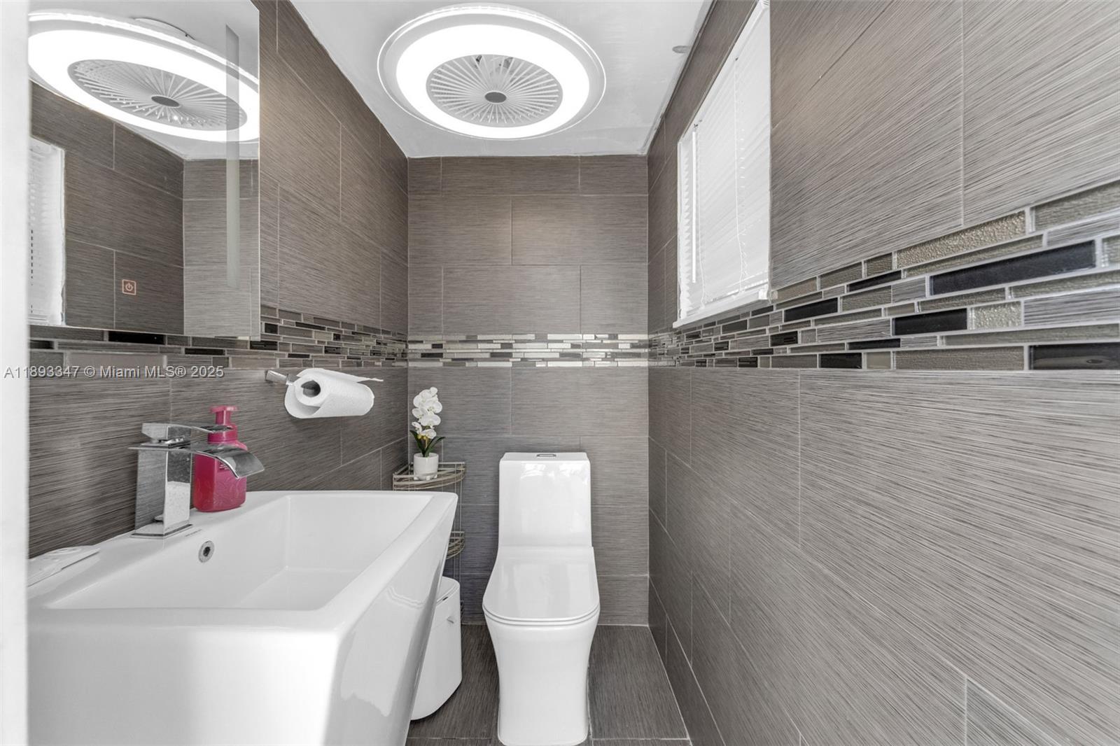 3121 Southwest 151st Court Miami, FL 33185 - Photo 23 of 37 a bathroom with a sink and a mirror