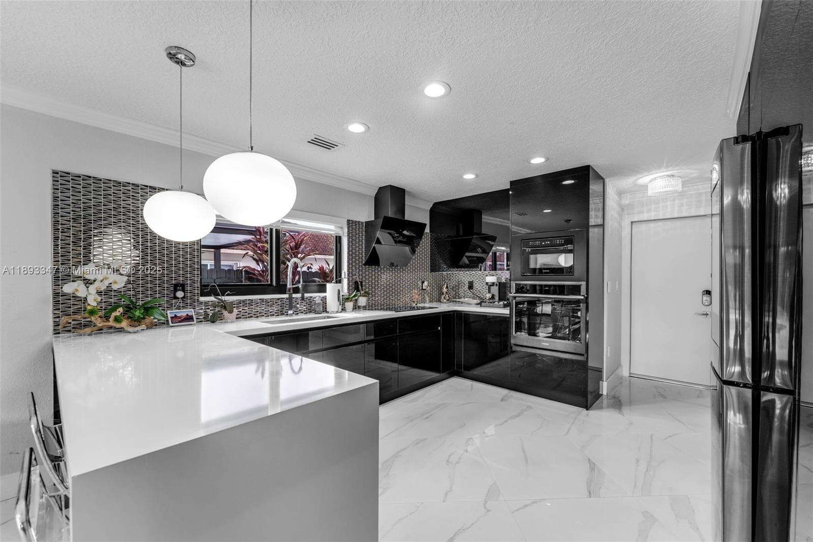 3121 Southwest 151st Court Miami, FL 33185 - Photo 10 of 37 a large kitchen with a sink and stainless steel appliances