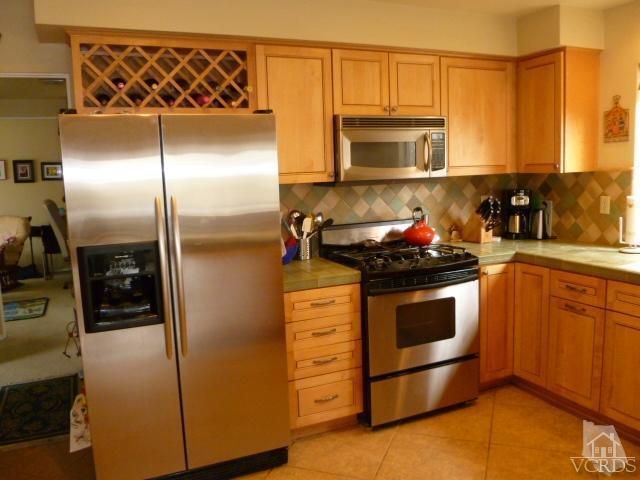 1421 Mandalay Beach Road Oxnard, CA 93035 - Photo 3 of 27 a kitchen with stainless steel appliances granite countertop a refrigerator and a sink