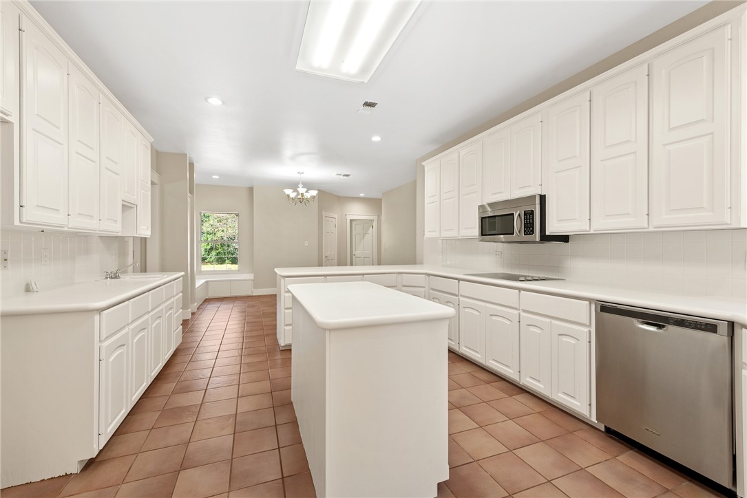 417 Morgan Street Franklin, TX 77856 - Photo 14 of 42 a large kitchen with stainless steel appliances granite countertop a sink and white cabinets