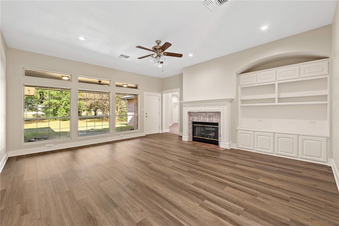 417 Morgan Street Franklin, TX 77856 - Photo 22 of 42 a view of a room with wooden floor fireplace and window