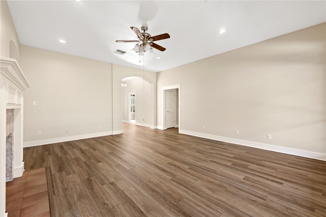 417 Morgan Street Franklin, TX 77856 - Photo 23 of 42 a view of an empty room with wooden floor and a ceiling fan