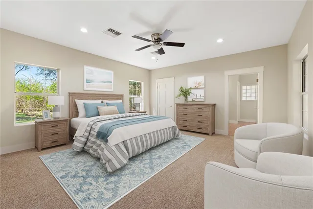 a view of a livingroom with a ceiling fan and window