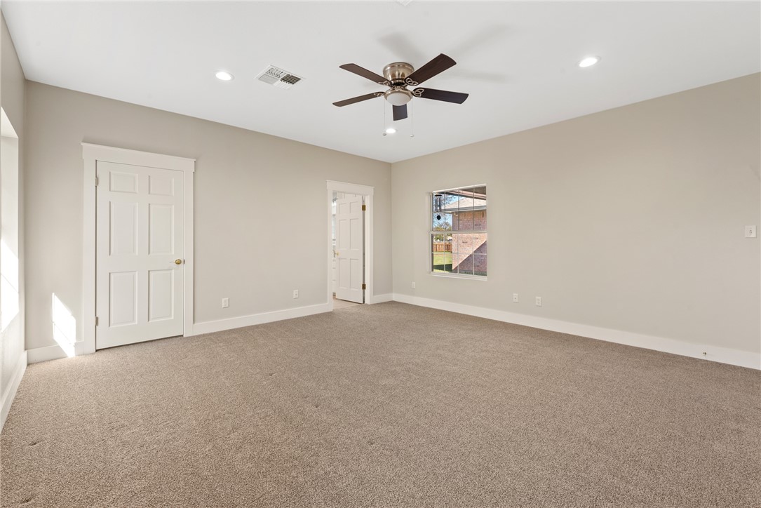 417 Morgan Street Franklin, TX 77856 - Photo 27 of 42 a view of a livingroom with a ceiling fan & windows