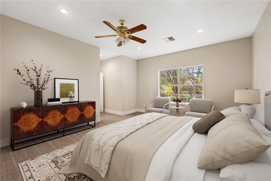417 Morgan Street Franklin, TX 77856 - Photo 31 of 42 a bedroom with a large bed and a chandelier