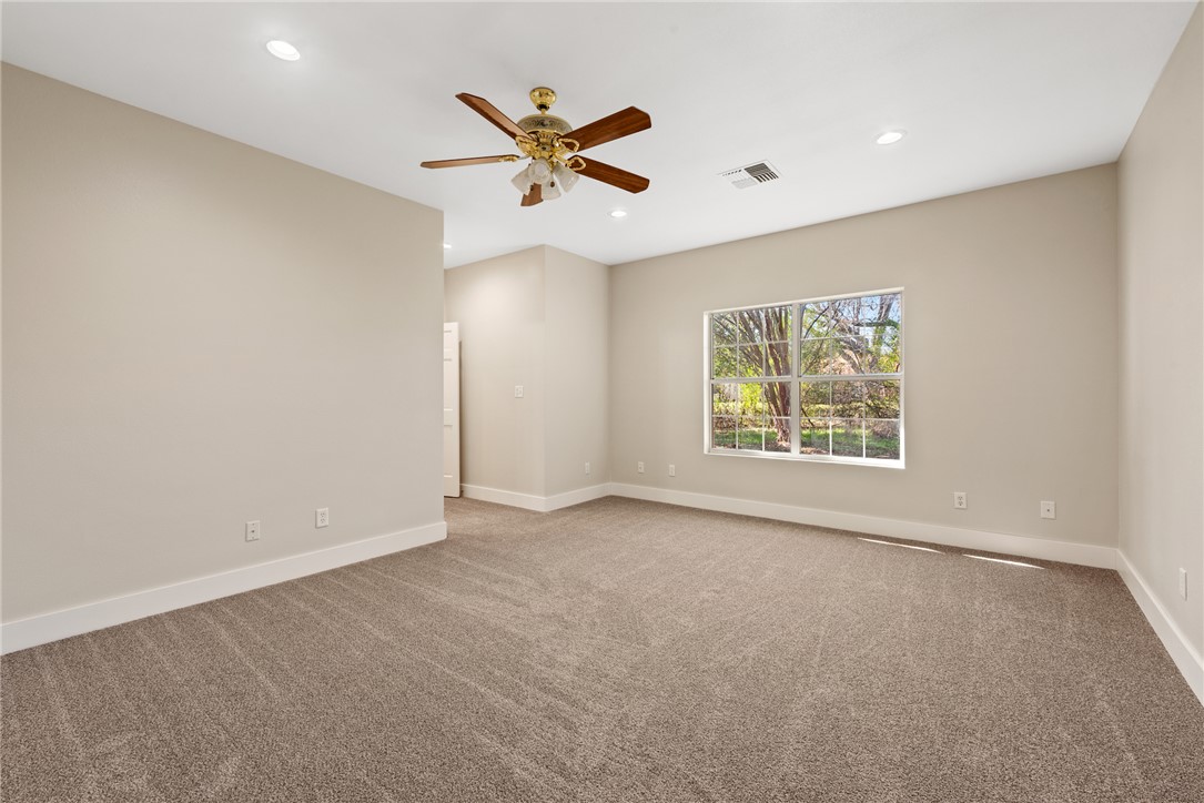 417 Morgan Street Franklin, TX 77856 - Photo 32 of 42 an empty room with windows and fan