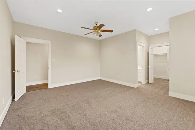 a spacious bathroom with a tub sink and mirror