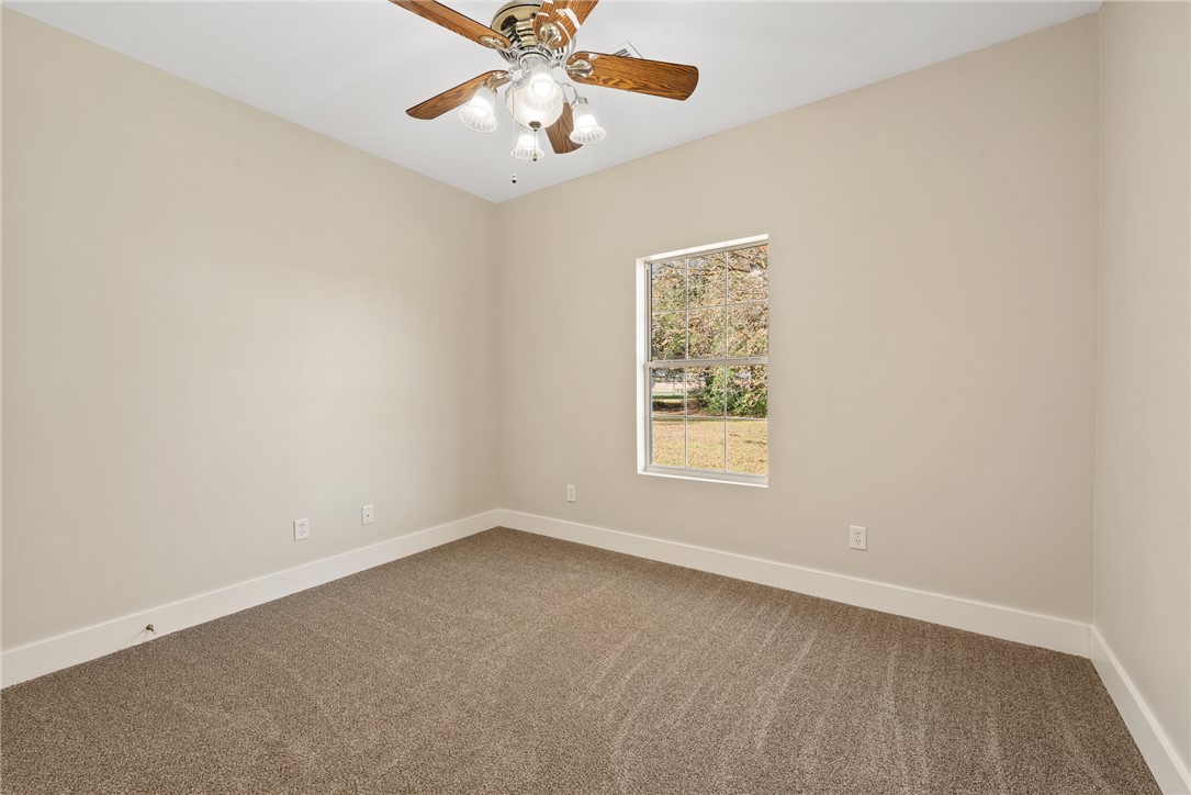 417 Morgan Street Franklin, TX 77856 - Photo 36 of 42 an empty room with a window and a fan