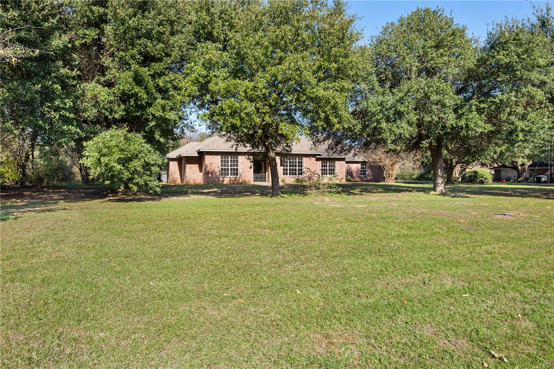 417 Morgan Street Franklin, TX 77856 - Photo 4 of 42 a front view of a house with a big yard