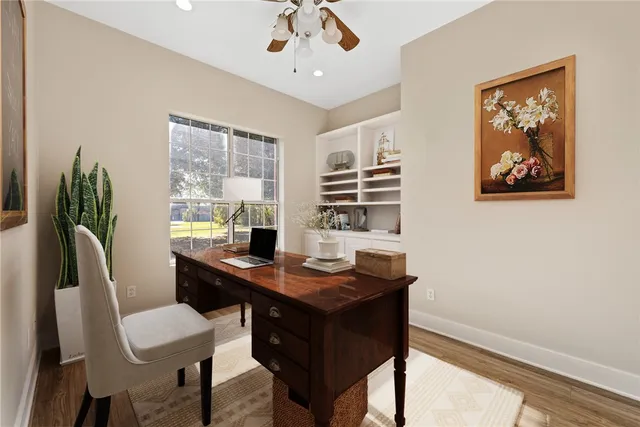 a view of a workspace with furniture and a window