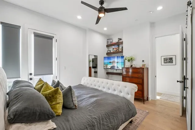 a bed room with a bed and a ceiling fan