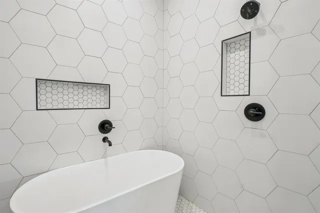 a bathroom with a bathtub and shower