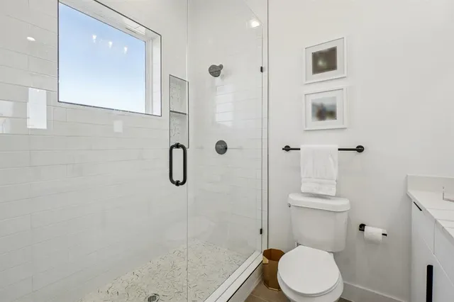 a white toilet sitting next to a bathroom sink