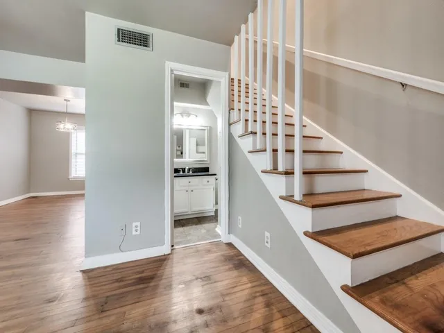 a view of entryway and hall with wooden floor