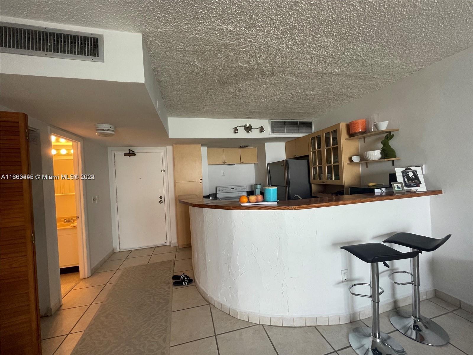 9273 Collins Avenue, Unit 811 Surfside, FL 33154 - Photo 12 of 25 a living room with furniture and a window