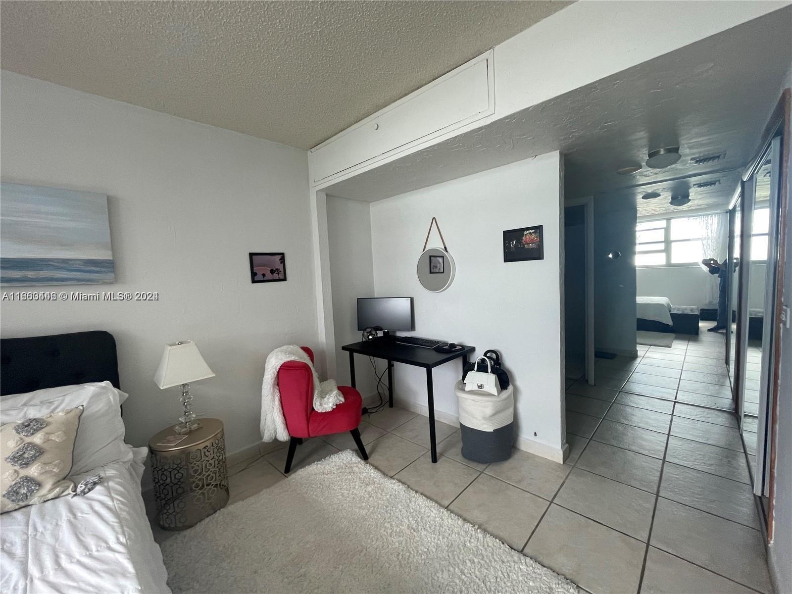 9273 Collins Avenue, Unit 811 Surfside, FL 33154 - Photo 19 of 25 a living room with furniture and a fireplace