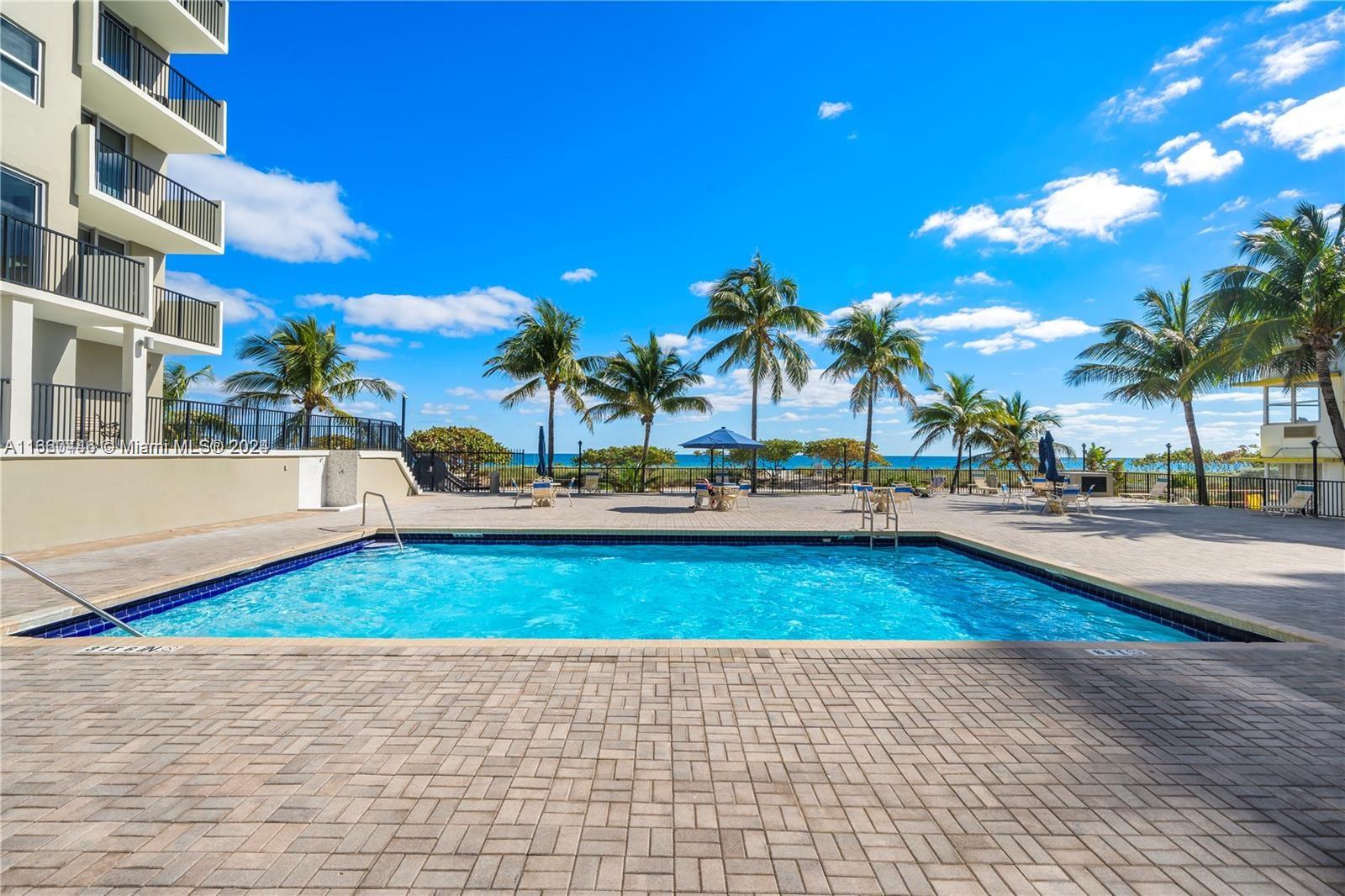 9273 Collins Avenue, Unit 811 Surfside, FL 33154 - Photo 23 of 25 a view of a swimming pool with an outdoor space