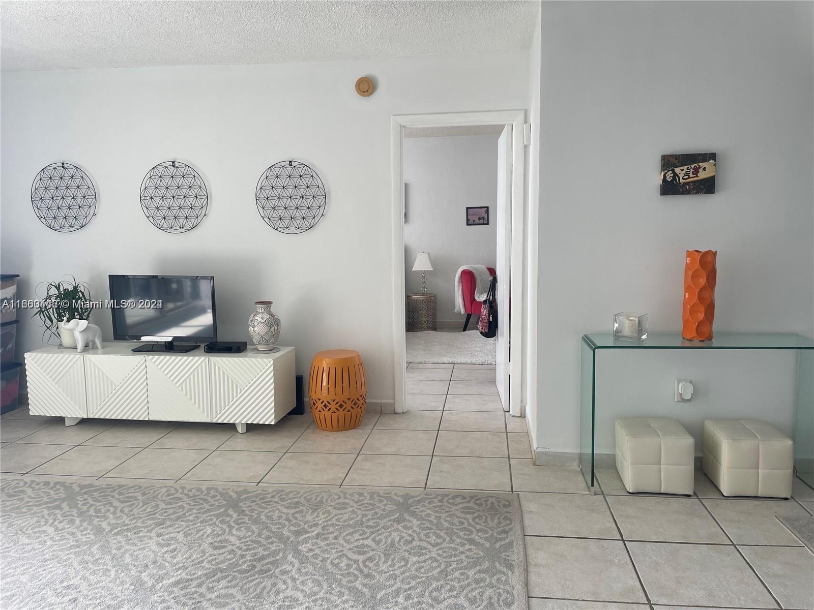 9273 Collins Avenue, Unit 811 Surfside, FL 33154 - Photo 5 of 25 a living room with furniture and a table