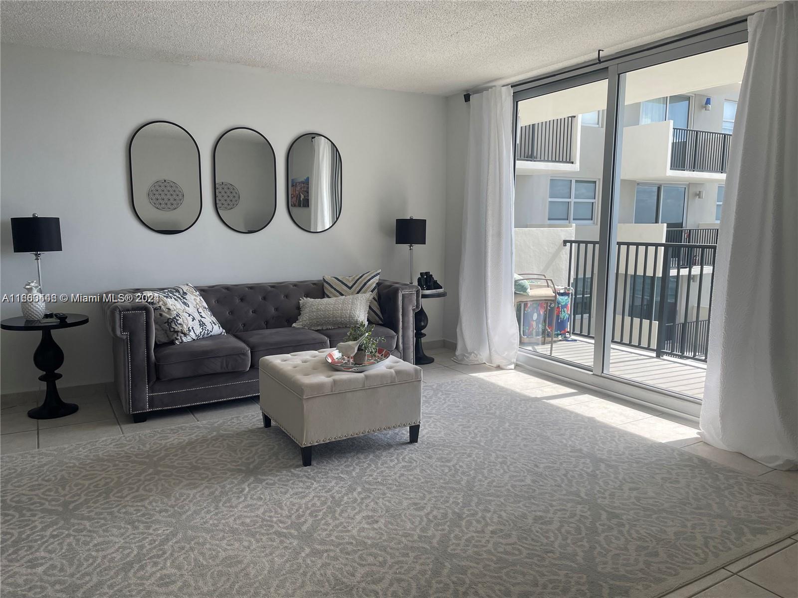 9273 Collins Avenue, Unit 811 Surfside, FL 33154 - Photo 6 of 25 a living room with furniture and a window
