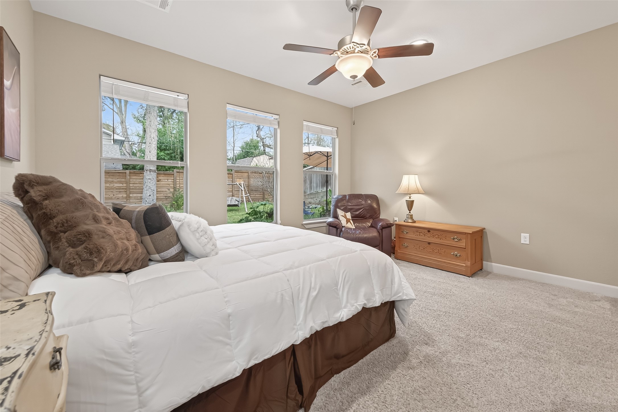 112 Timberside Drive Conroe, TX 77304 - Photo 19 of 50 a large bed sitting in a bedroom next to a window