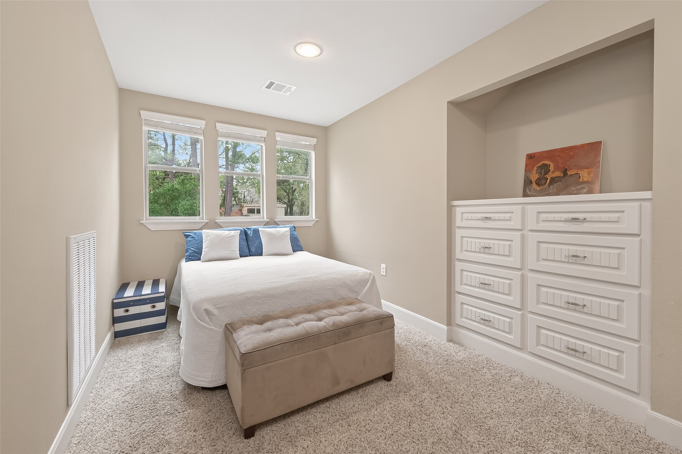 112 Timberside Drive Conroe, TX 77304 - Photo 36 of 50 a bedroom with a bed and a dresser