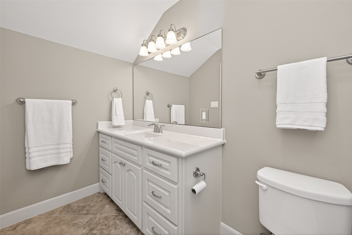 112 Timberside Drive Conroe, TX 77304 - Photo 41 of 50 a bathroom with a granite countertop sink a toilet and a mirror