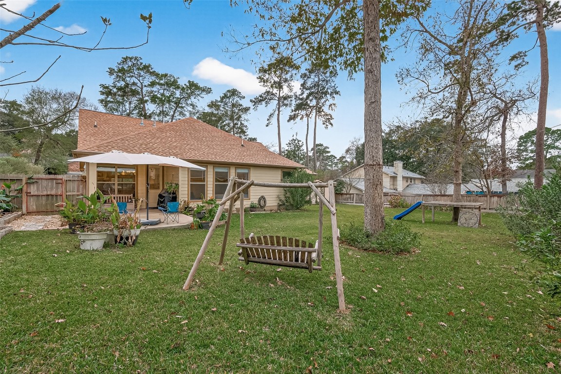 112 Timberside Drive Conroe, TX 77304 - Photo 46 of 50 a front view of a house with a garden
