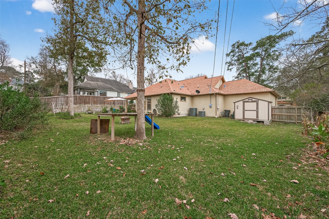 112 Timberside Drive Conroe, TX 77304 - Photo 47 of 50 a white house with a big yard and large trees