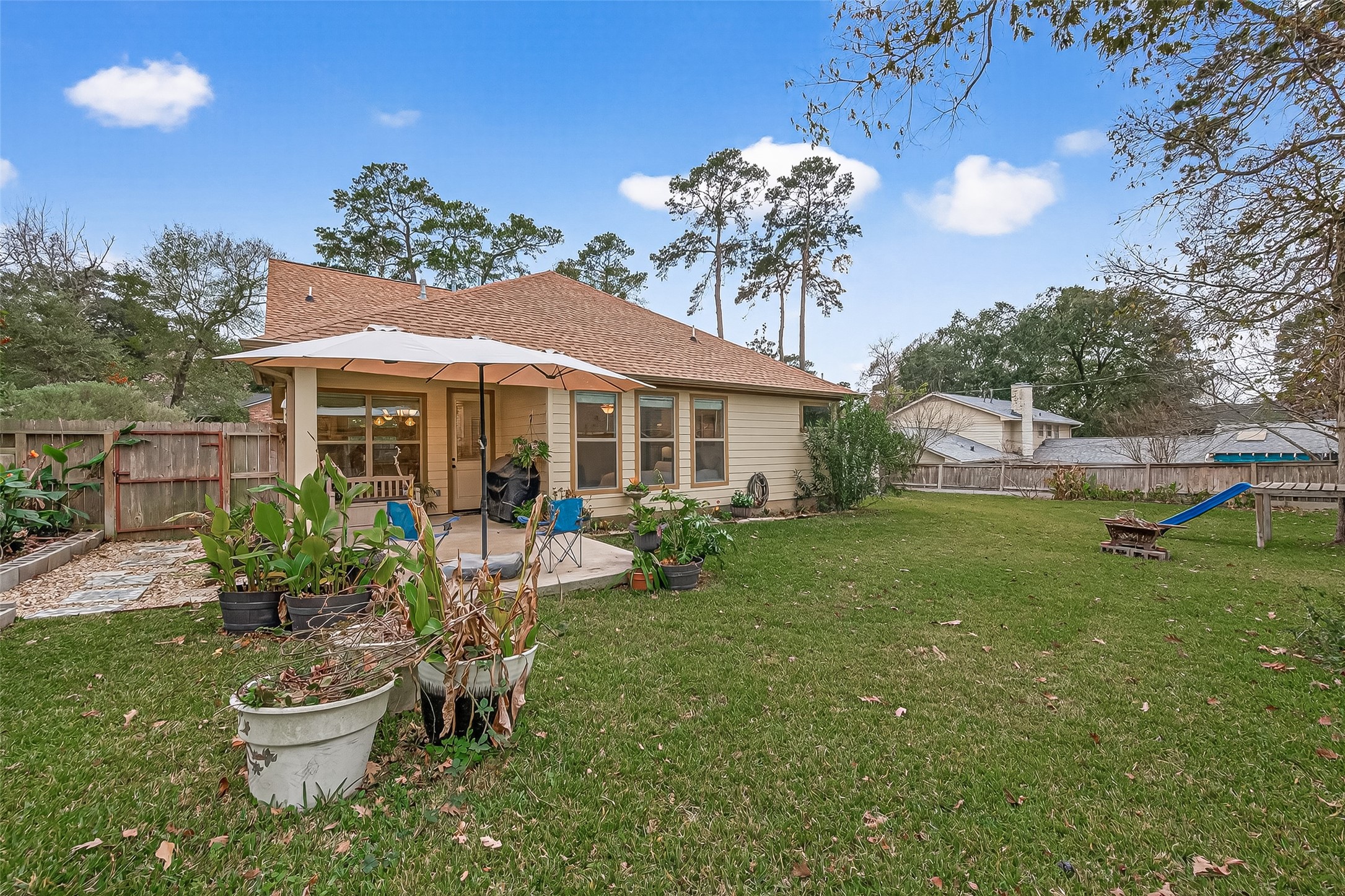 112 Timberside Drive Conroe, TX 77304 - Photo 49 of 50 a view of a house with backyard sitting area and garden