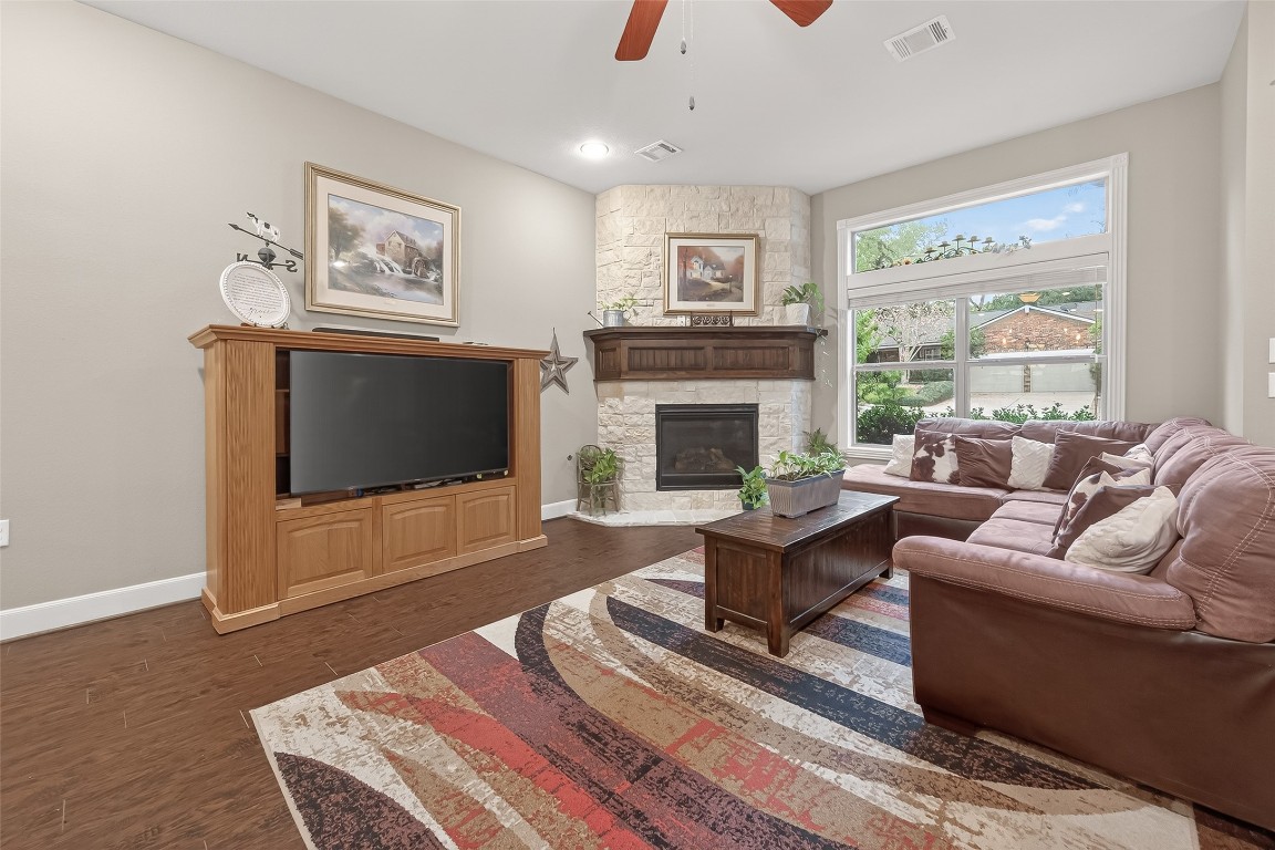 112 Timberside Drive Conroe, TX 77304 - Photo 6 of 50 a living room with furniture a flat screen tv and a fireplace