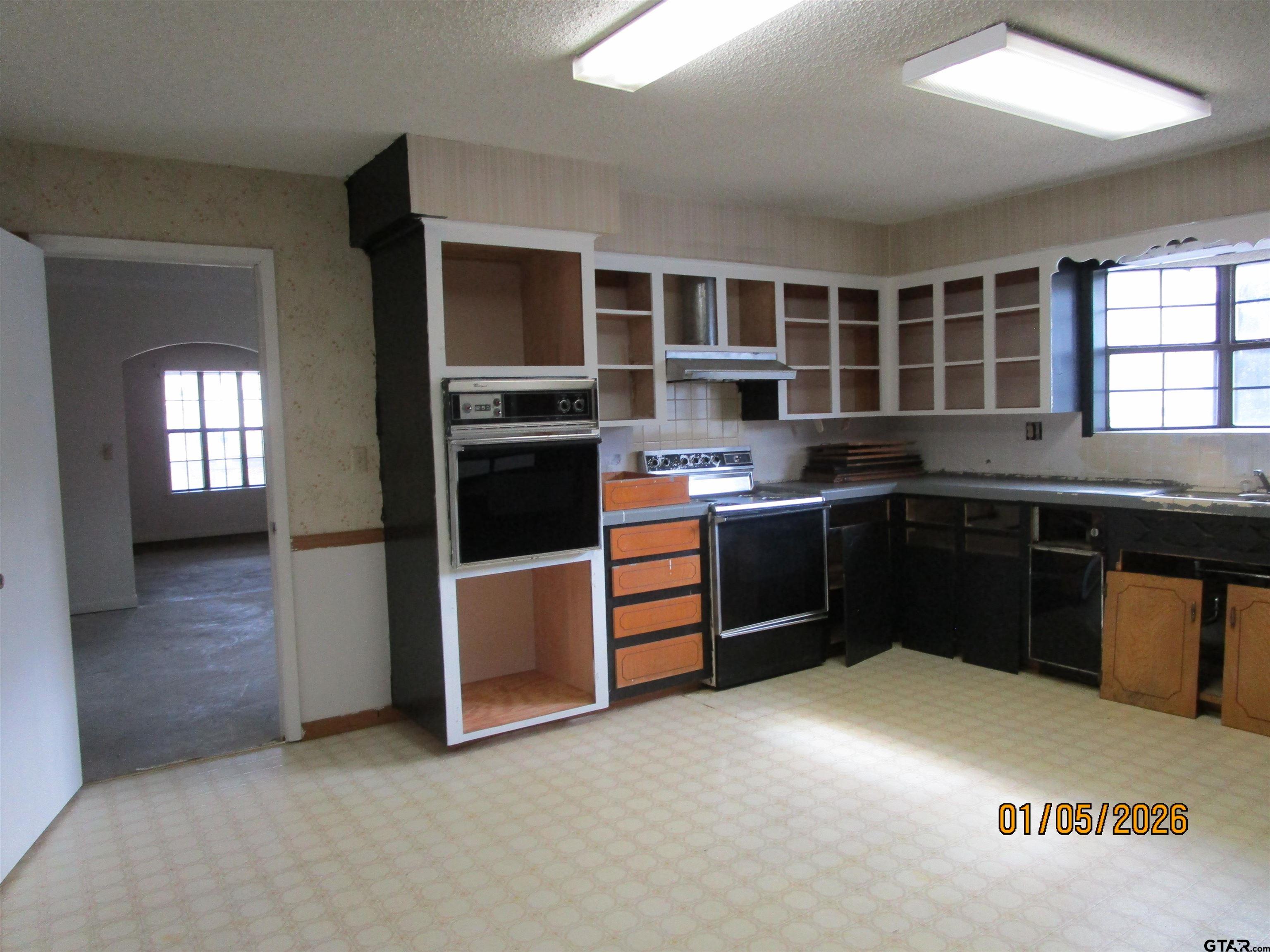1317 South Butler Avenue Tyler, TX 75701 - Photo 11 of 13 a kitchen with stainless steel appliances granite countertop a stove and a sink
