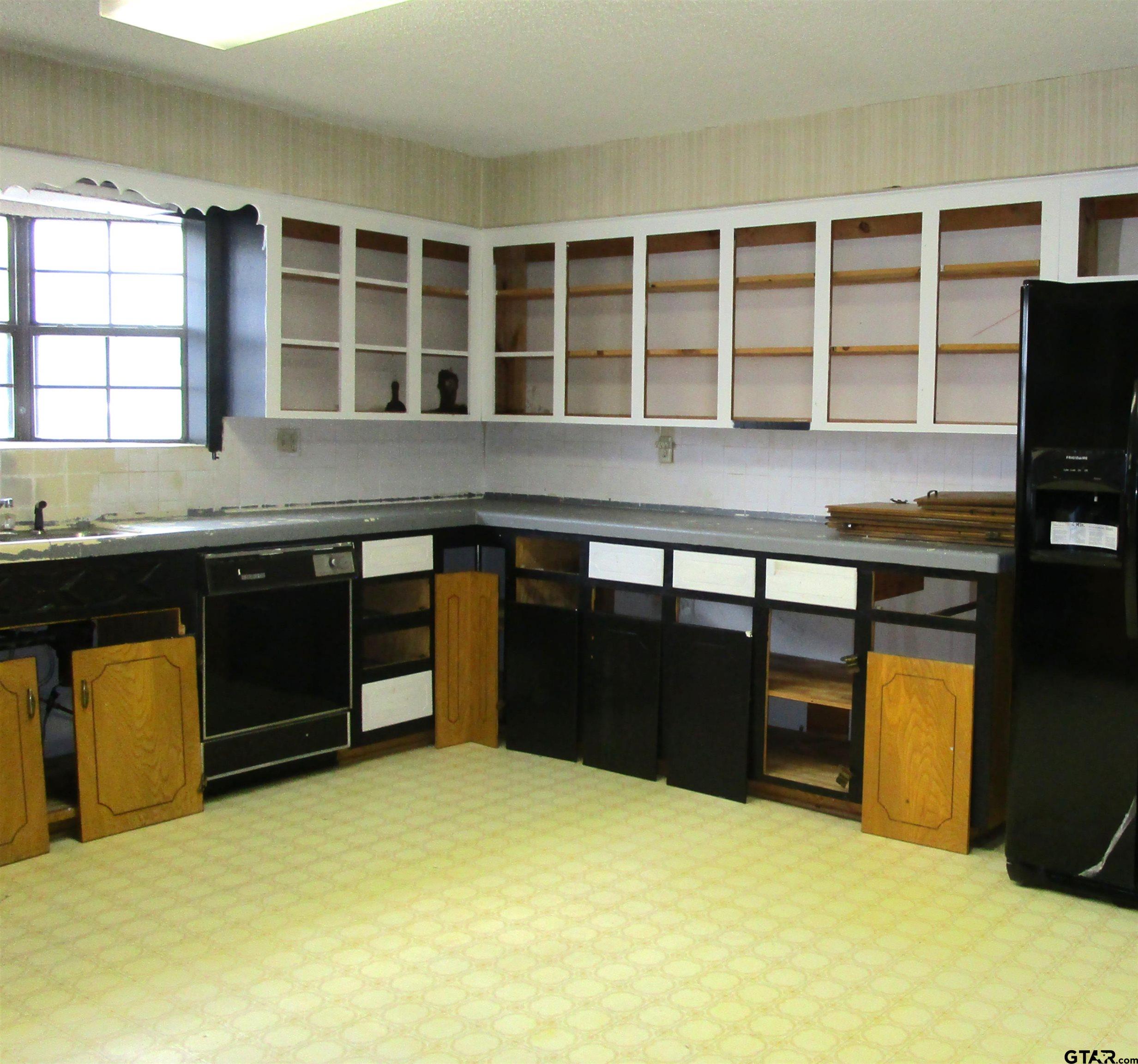 1317 South Butler Avenue Tyler, TX 75701 - Photo 12 of 13 a kitchen with stainless steel appliances granite countertop a stove and cabinets